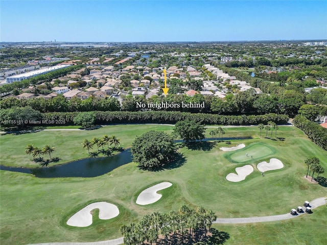 bird's eye view featuring golf course view and a water view