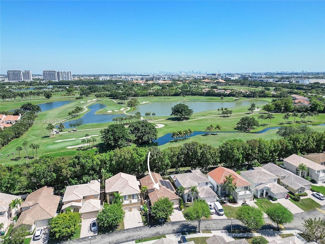 drone / aerial view with a residential view, a water view, and view of golf course