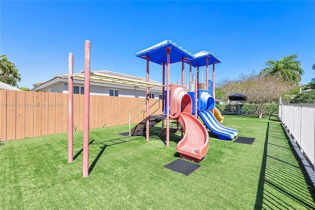 view of play area with a yard and fence