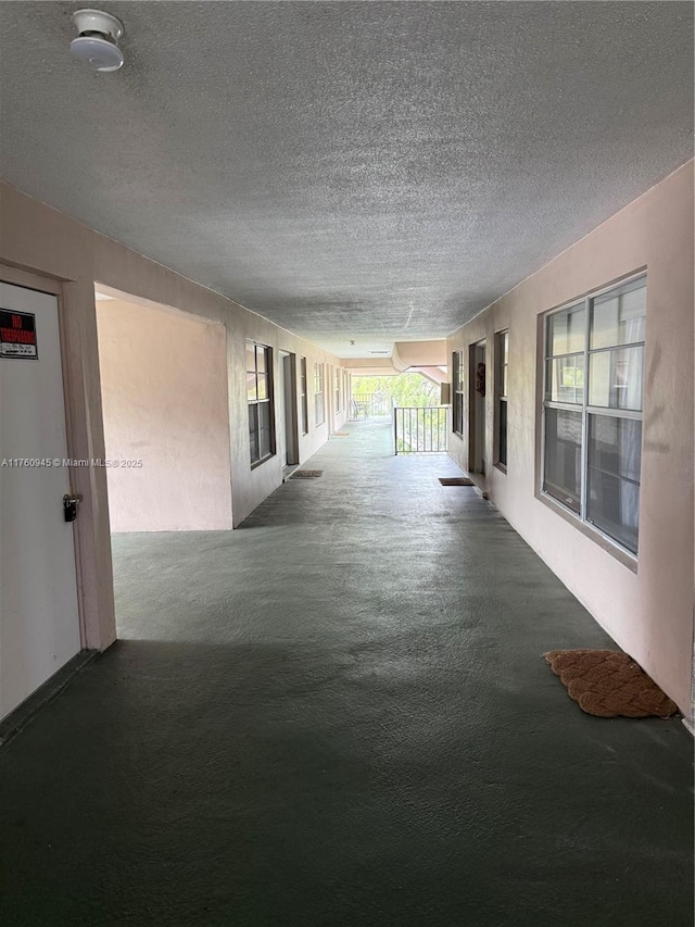 corridor featuring a textured ceiling