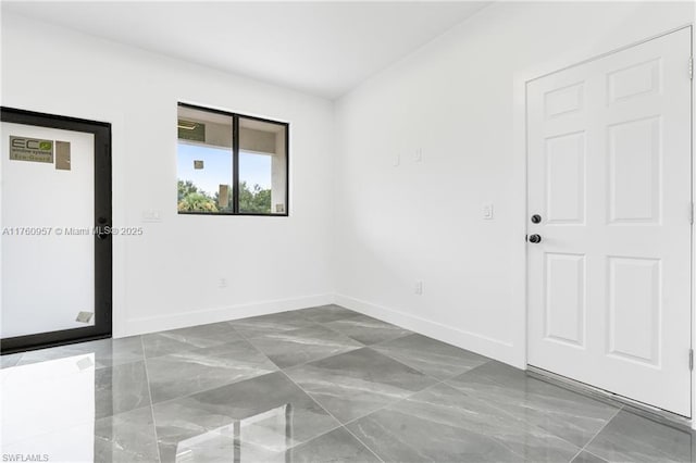 empty room featuring baseboards