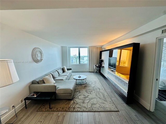 living area with wood finished floors and baseboards