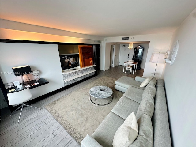 living room with wood finished floors and visible vents