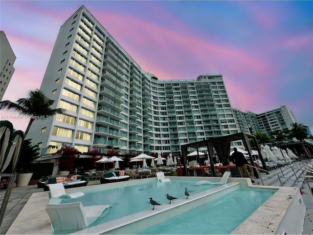 view of pool at dusk