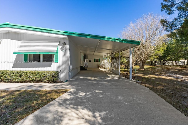 exterior space featuring an attached carport and driveway