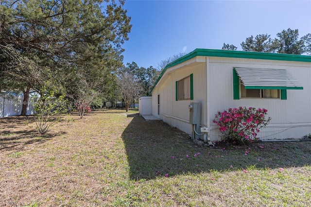 view of side of home featuring a lawn