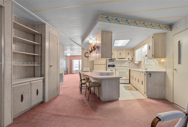 kitchen with light carpet, white appliances, light countertops, and under cabinet range hood