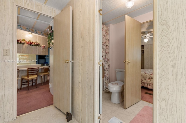 ensuite bathroom featuring toilet and connected bathroom