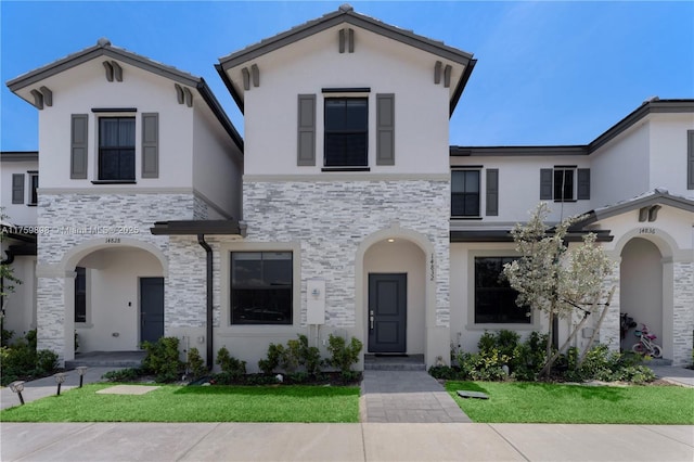 view of front of house with stone siding and stucco siding