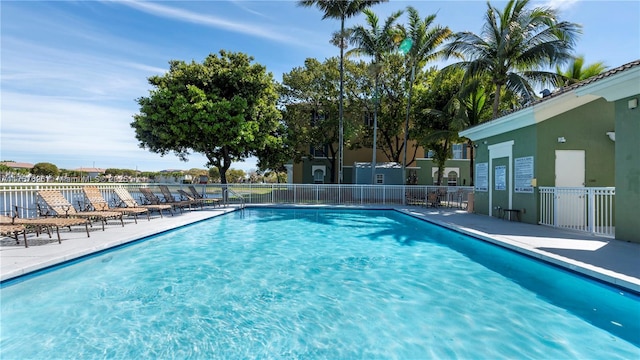 pool featuring a patio and fence