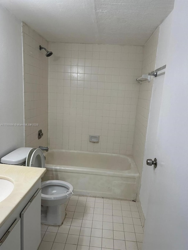 full bathroom featuring toilet, a textured ceiling,  shower combination, tile patterned flooring, and vanity