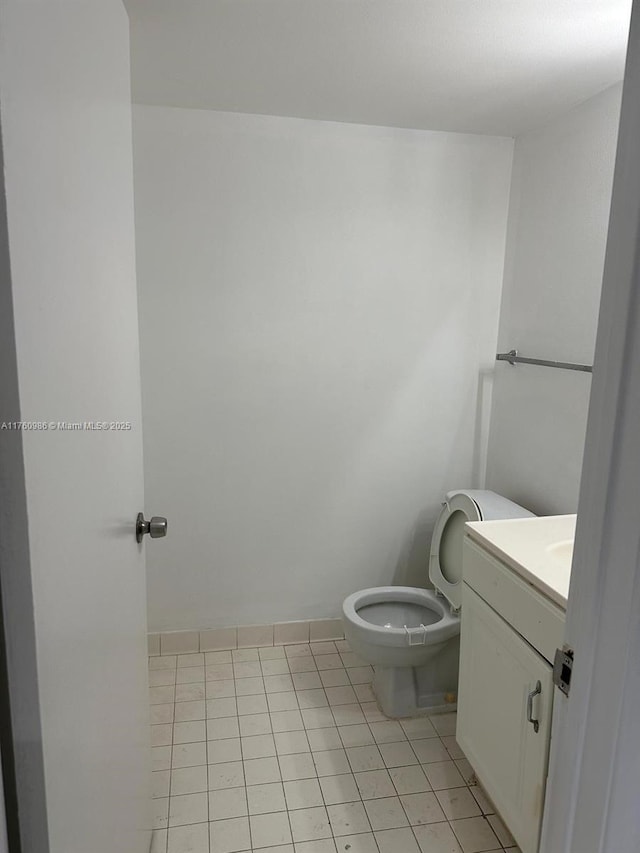 bathroom featuring tile patterned floors, toilet, and vanity