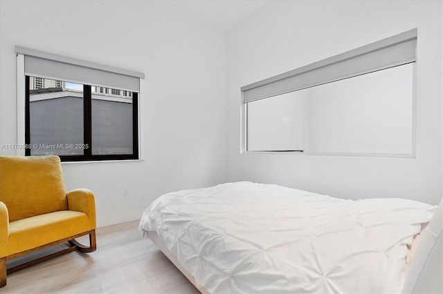 bedroom featuring baseboards and light wood-style floors