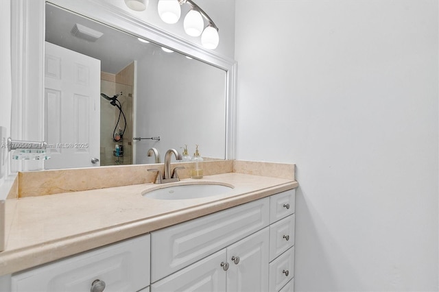 full bath featuring visible vents, vanity, and a shower