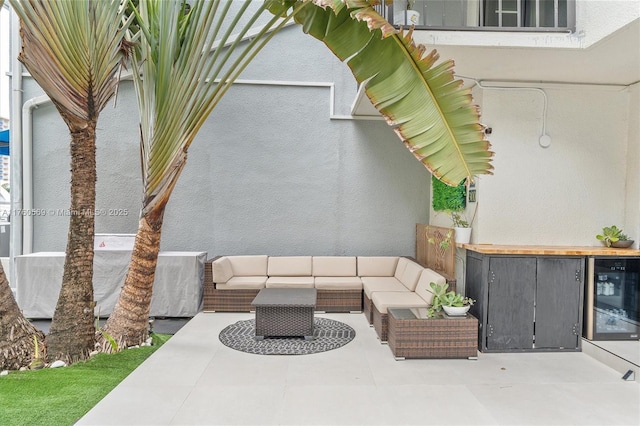 view of patio / terrace featuring beverage cooler and outdoor lounge area