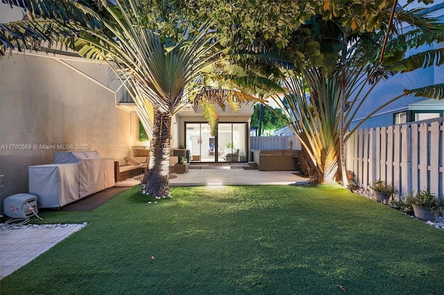 view of yard with a patio, a fenced backyard, french doors, outdoor lounge area, and a hot tub