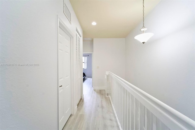 8861 W 35th Ave, Hialeah, FL 33018 - hall featuring visible vents, an upstairs landing, light wood-style flooring, recessed lighting, and a decorative wall