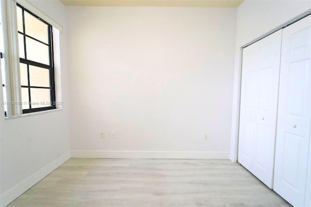 8861 W 35th Ave, Hialeah, FL 33018 - unfurnished bedroom featuring light wood-style flooring, baseboards, and a closet