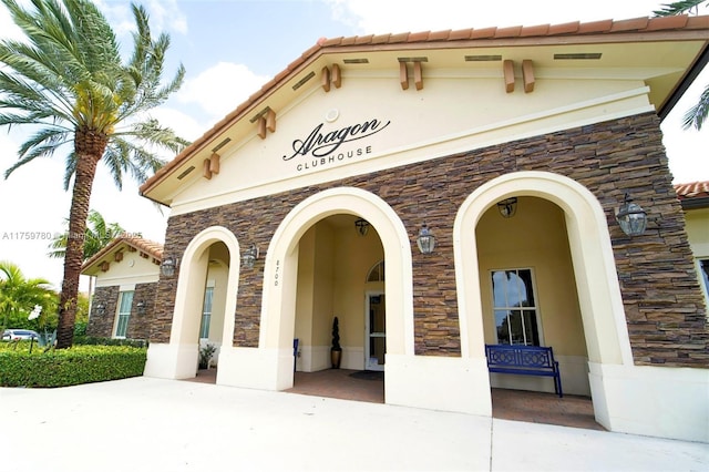 8861 W 35th Ave, Hialeah, FL 33018 - property entrance with a tile roof, stone siding, and stucco siding