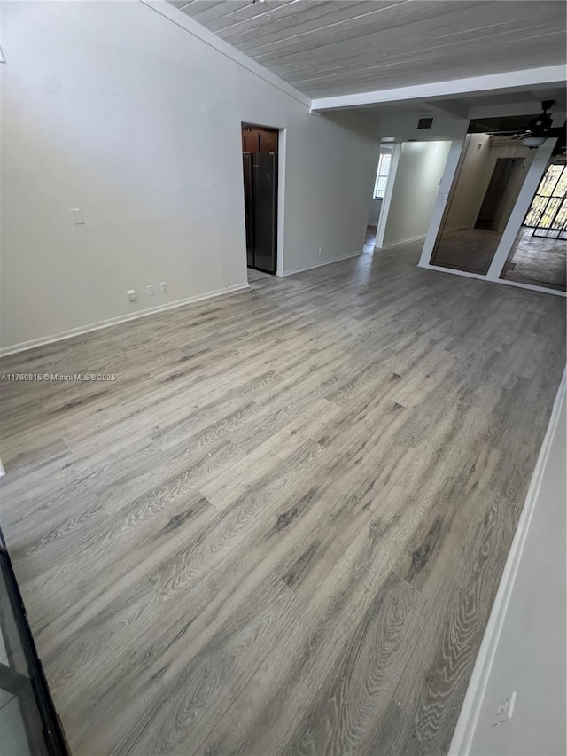 interior space featuring visible vents, wood ceiling, wood finished floors, and baseboards