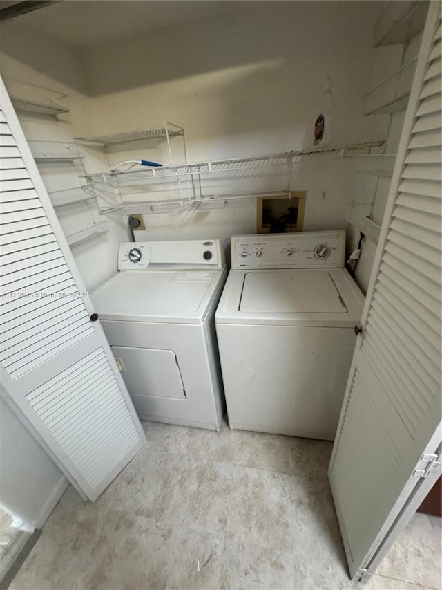 washroom featuring laundry area and washing machine and dryer