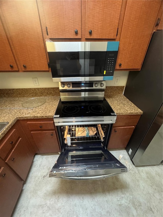 kitchen with stainless steel appliances and brown cabinets