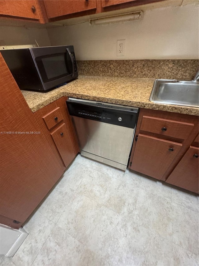 kitchen featuring a sink, brown cabinets, dishwasher, and black microwave