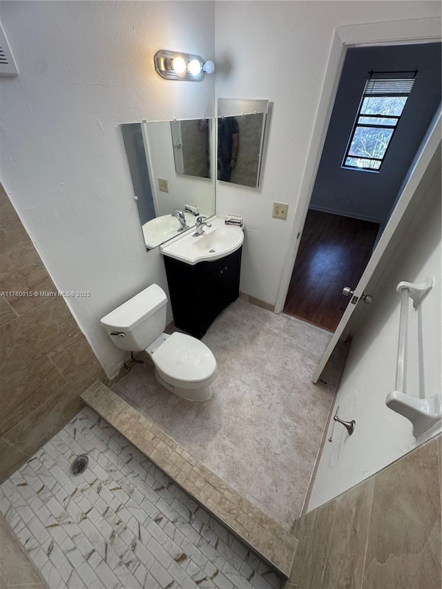 bathroom with tile patterned flooring, toilet, and vanity