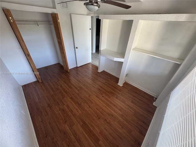 unfurnished bedroom featuring visible vents, a ceiling fan, and wood finished floors