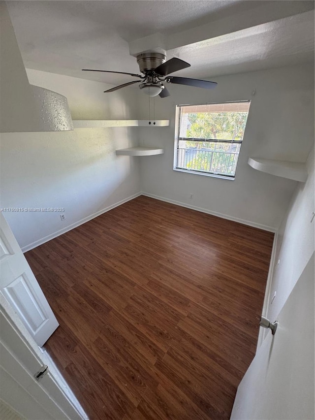 unfurnished room with ceiling fan, baseboards, a textured ceiling, and wood finished floors