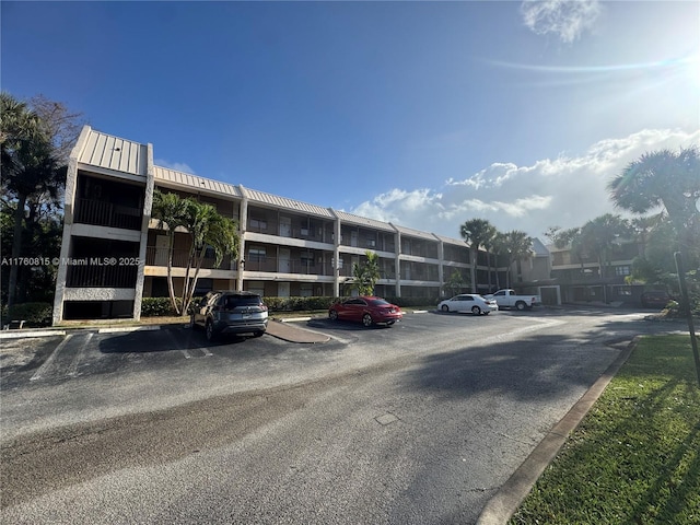 view of property featuring uncovered parking