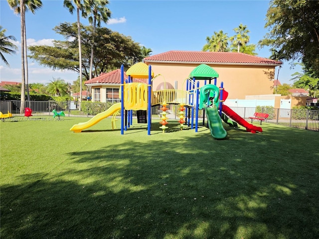 communal playground with a yard and fence