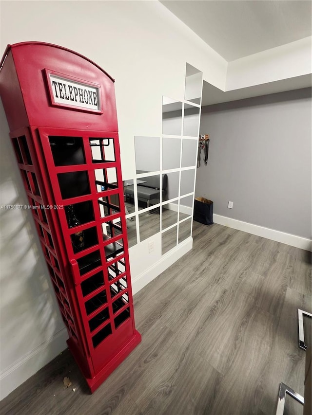 interior space featuring baseboards and wood finished floors