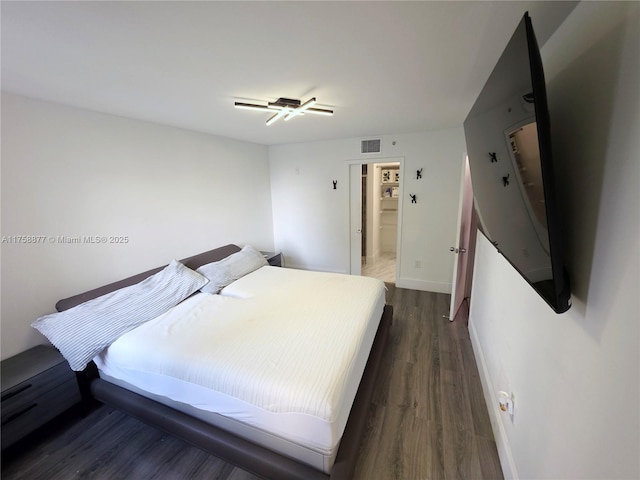 bedroom with visible vents, dark wood-style floors, and baseboards