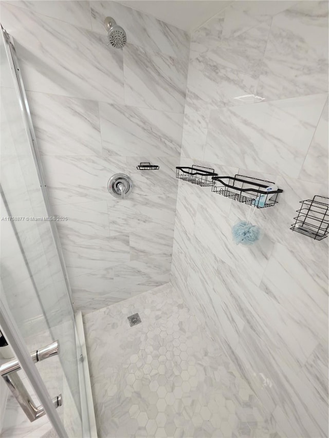 full bathroom with a tile shower