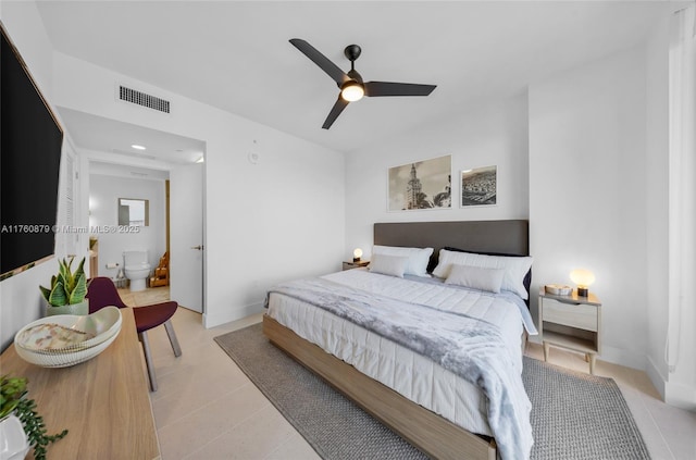 bedroom featuring light tile patterned floors, a ceiling fan, visible vents, baseboards, and connected bathroom