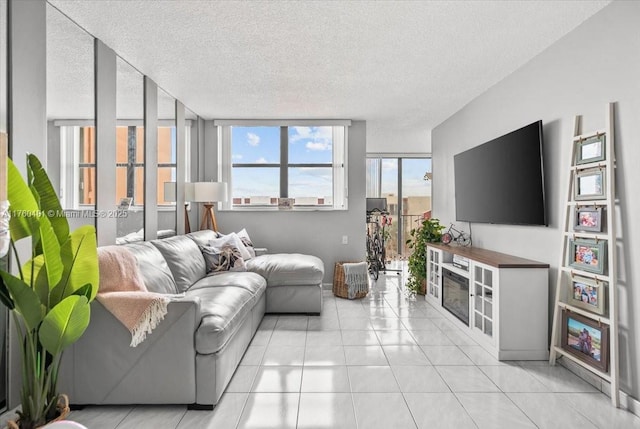 living room featuring light tile patterned floors and a textured ceiling