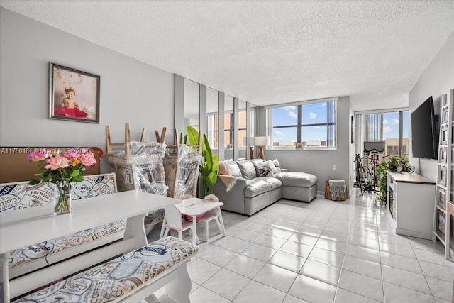 living room with light tile patterned flooring and a textured ceiling