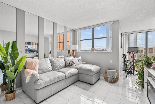 living room featuring light tile patterned floors, a wealth of natural light, and a textured ceiling