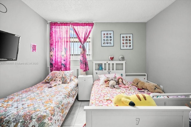 bedroom featuring a textured ceiling and tile patterned flooring