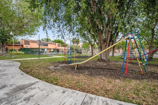 community playground with a yard and fence