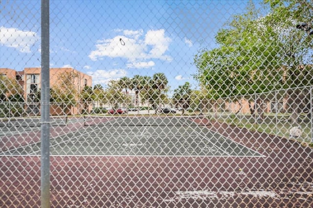 view of tennis court with fence