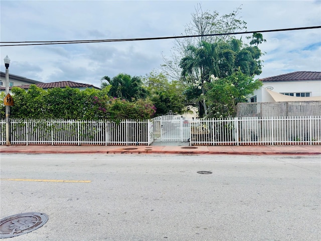 exterior space with curbs, sidewalks, and street lighting