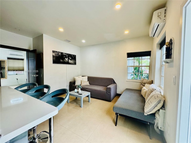 living area with an AC wall unit, recessed lighting, light tile patterned floors, and visible vents