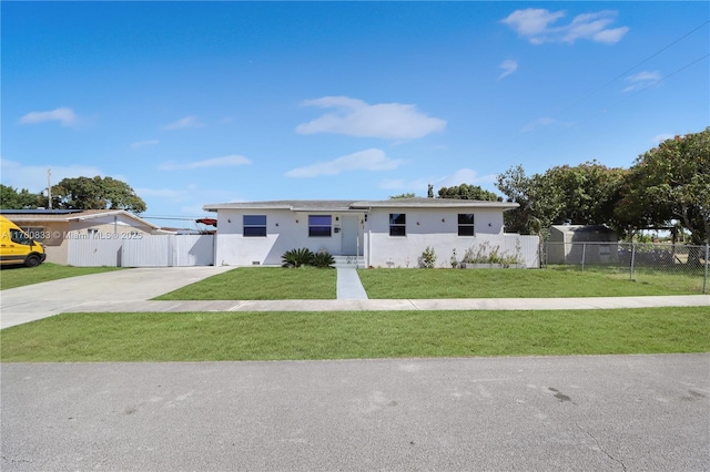 view of front facade with stucco siding, a front lawn, and fence