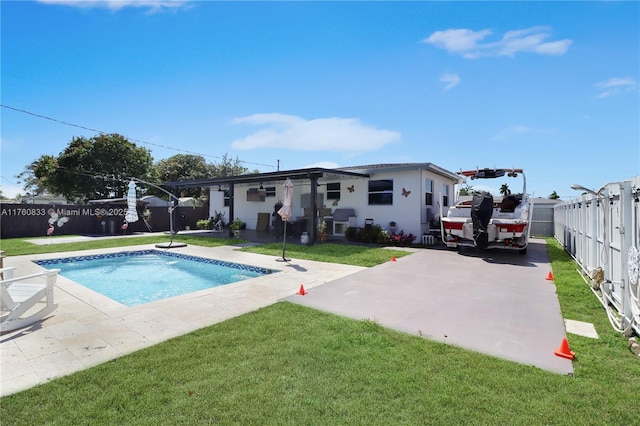 rear view of property with a yard, a patio, and a fenced backyard