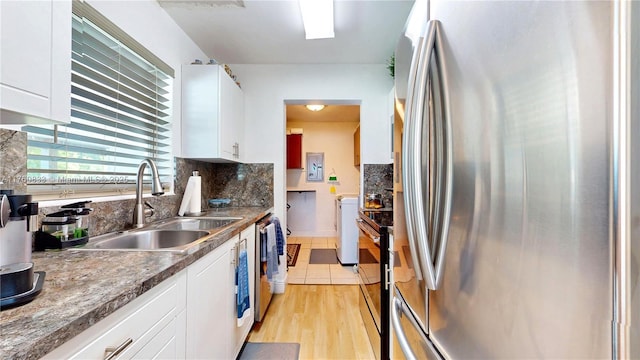 kitchen featuring a sink, backsplash, stainless steel appliances, white cabinets, and light wood finished floors