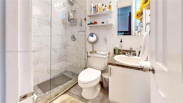 bathroom with vanity, toilet, and a shower stall