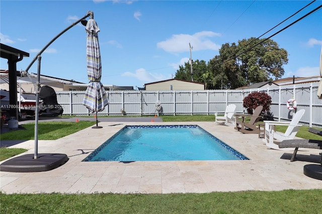 view of swimming pool featuring a fenced backyard, a fenced in pool, and a patio