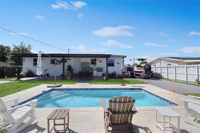 view of swimming pool with a fenced in pool, a patio, and fence